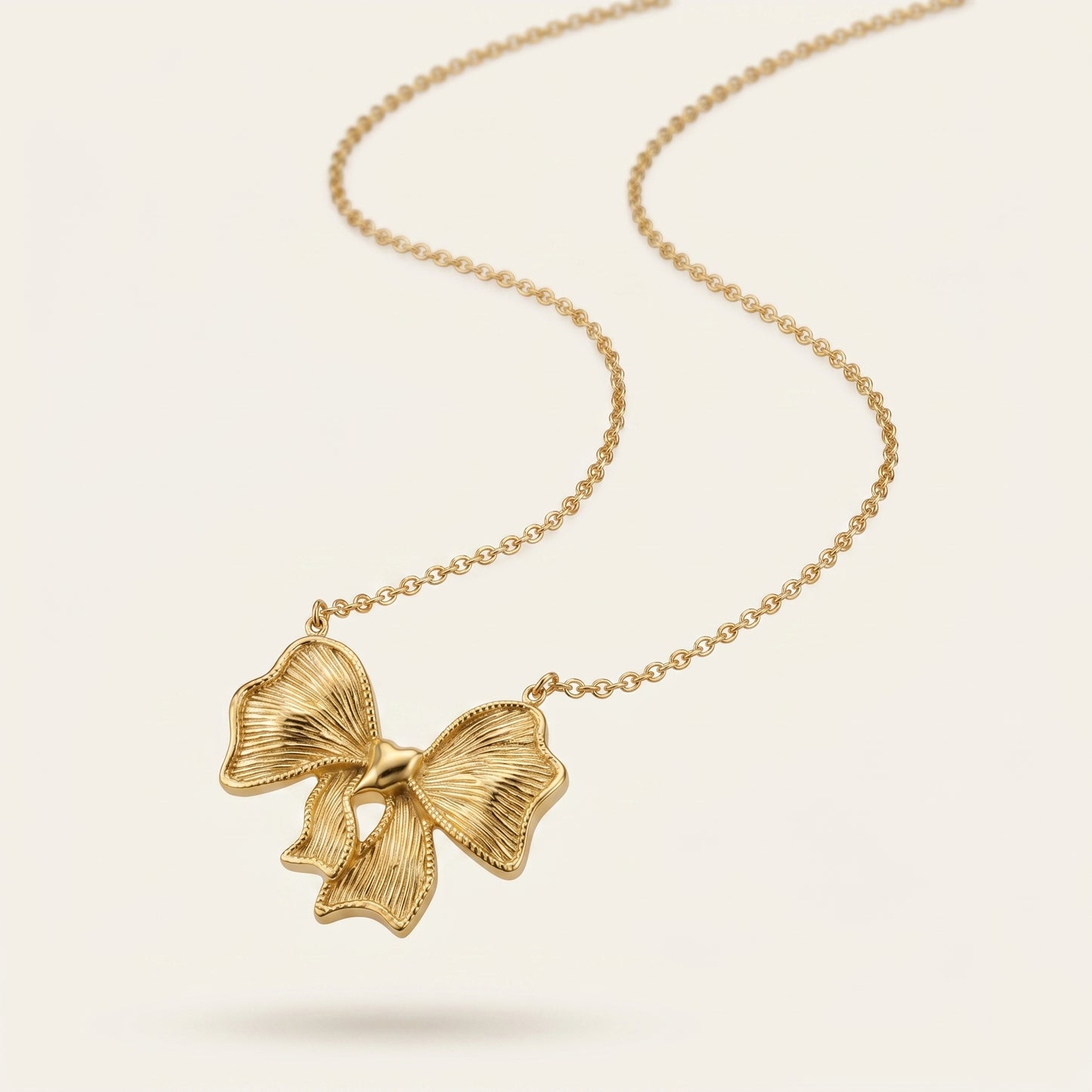 Twinkle Tie – Gold Bow Pendant Necklace